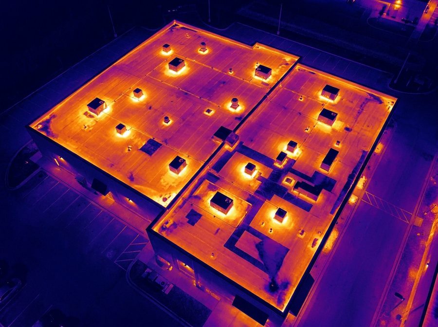 Aerial thermal imaging showing heat anomalies across a commercial roof