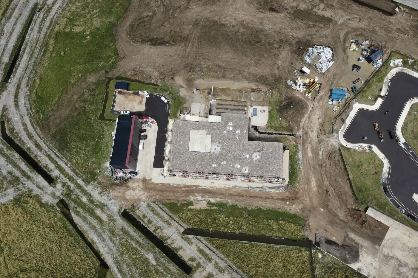 Top-down aerial orthomosaic map of a construction site and surrounding land