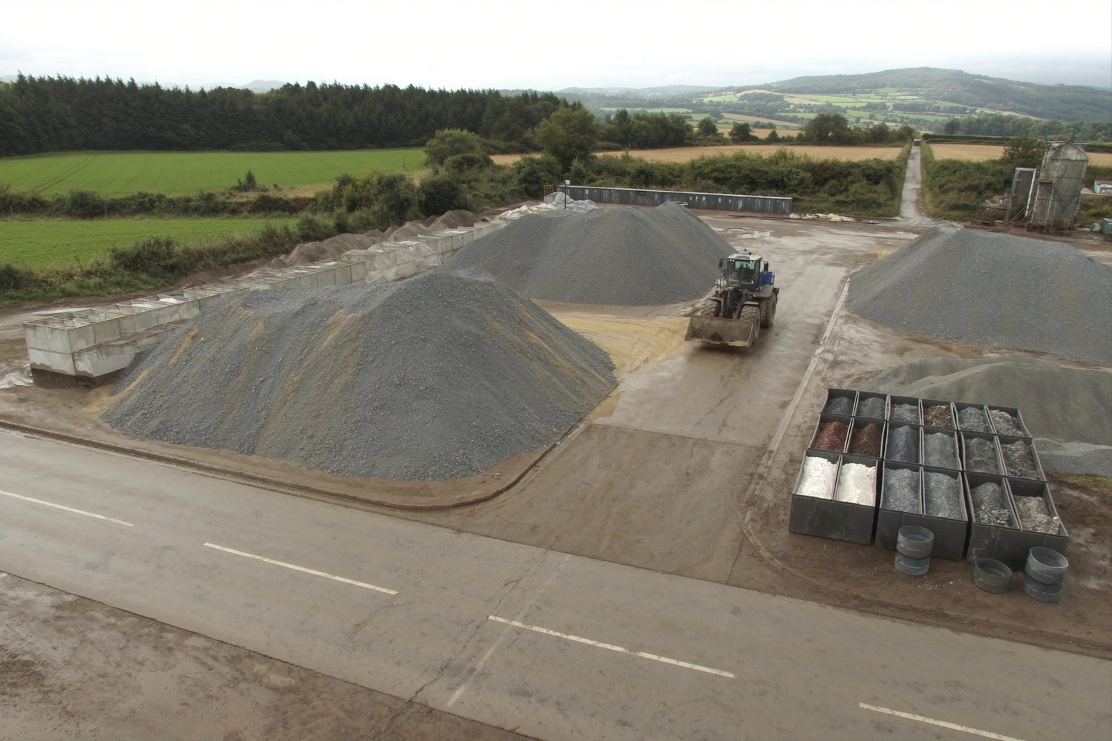 Aerial drone view of aggregate stockpiles at a materials yard